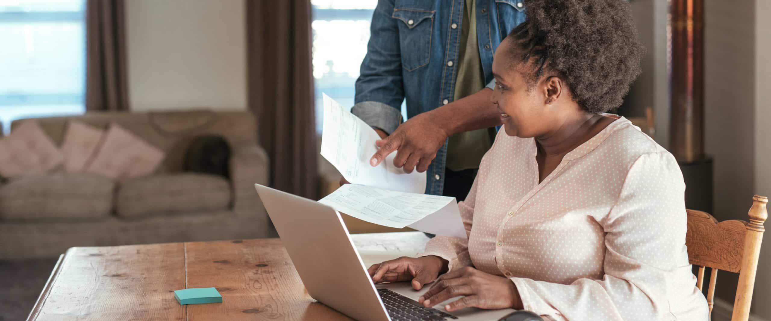 Young couple paying bills online