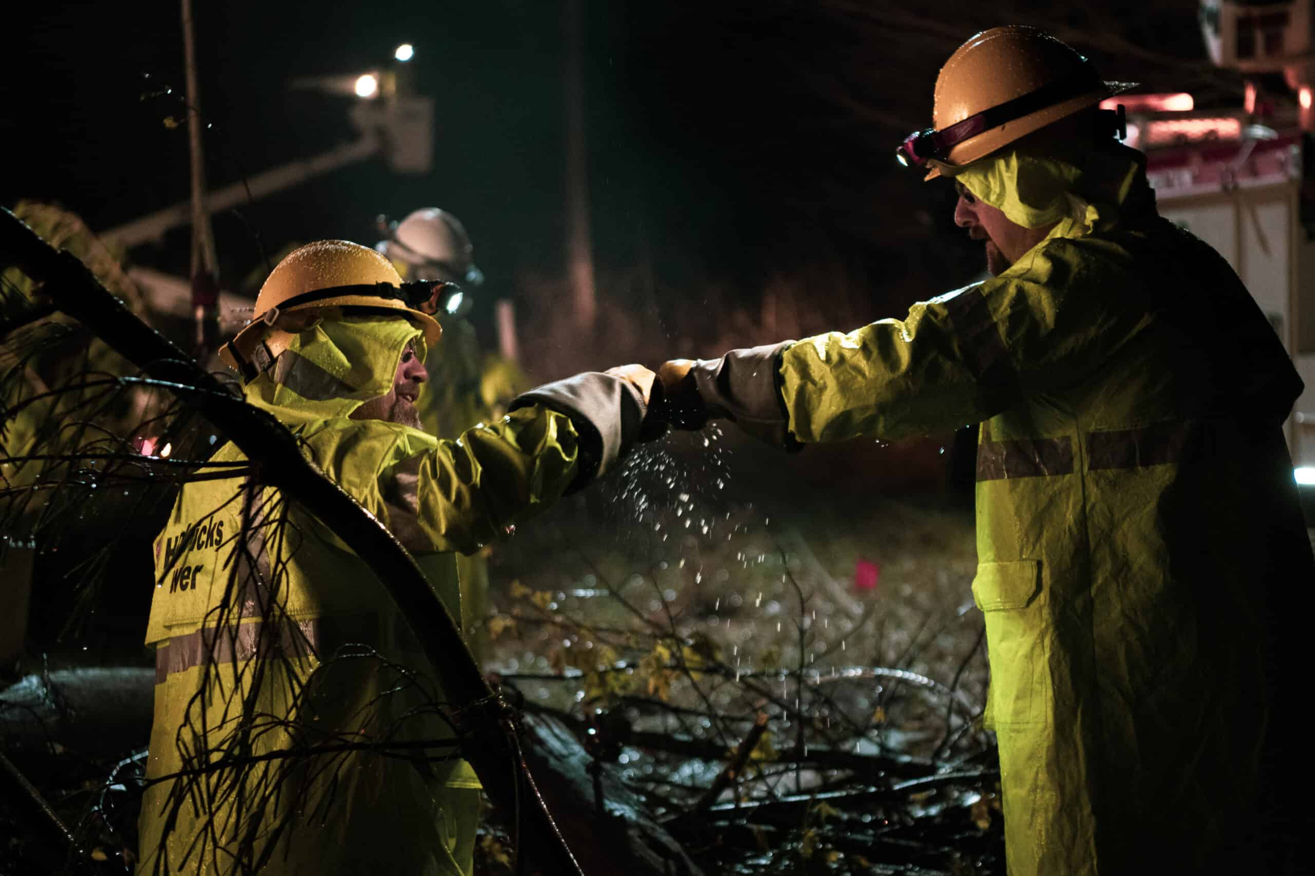 Linemen work to restore power in this nighttime photo